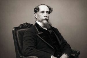 Charles Dickens Museum - London - Historisches Porträt des Autors Charles Dickens, sitzend in einem verzierten Sessel