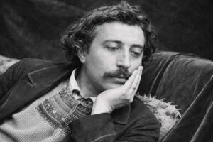 Paul Gauguin - Schwarz-Weiß-Foto des Künstlers, der nachdenklich seinen Kopf auf die Hand stützt.